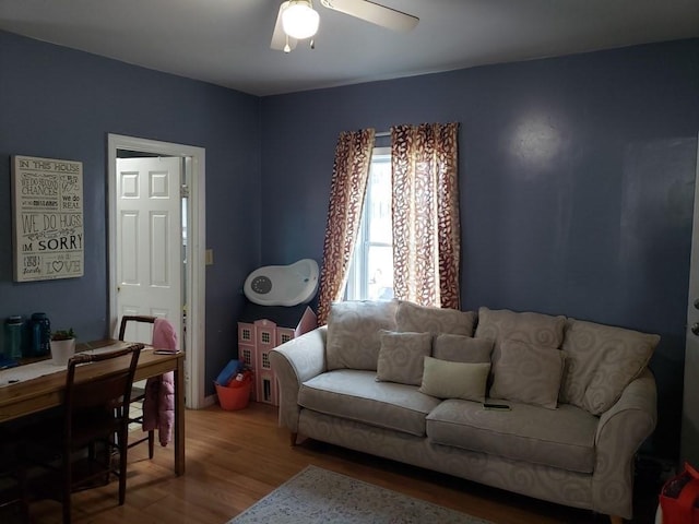 living room with wood-type flooring and ceiling fan