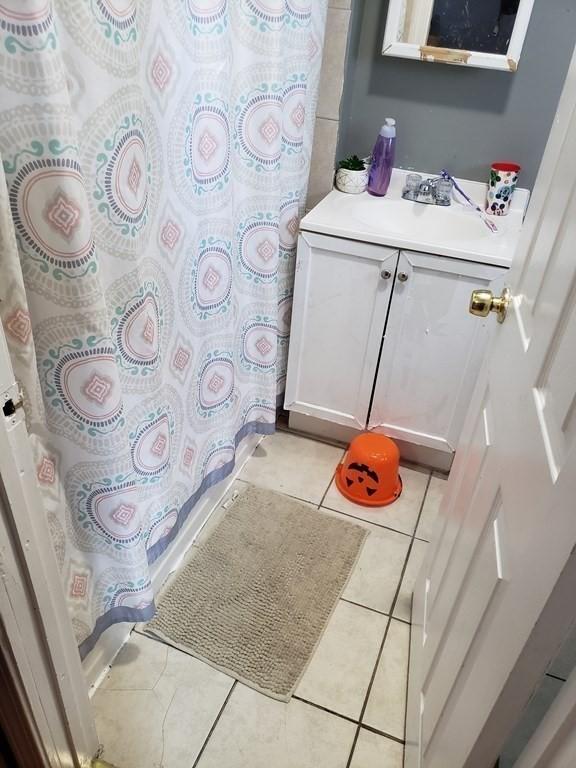 bathroom with tile patterned floors and vanity