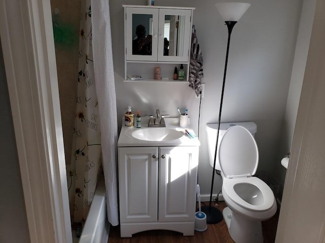 full bathroom featuring toilet, shower / tub combo with curtain, vanity, and hardwood / wood-style flooring