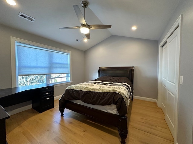 bedroom featuring a closet, ceiling fan, vaulted ceiling, and light hardwood / wood-style floors