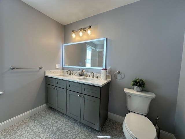 bathroom featuring toilet, vanity, and tile patterned flooring