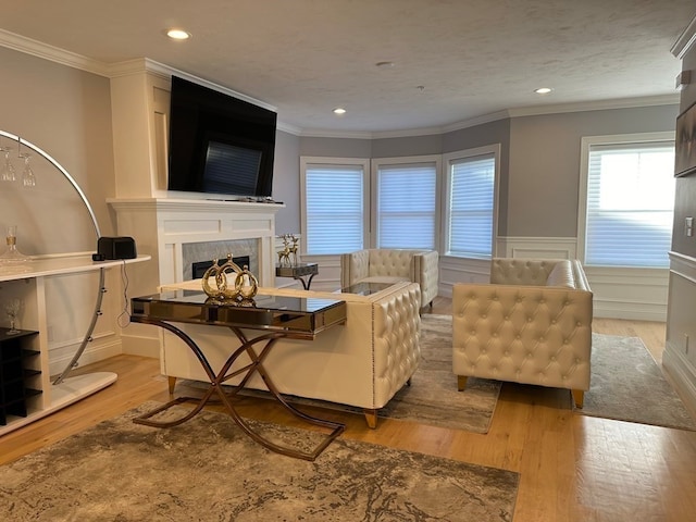 living room featuring ornamental molding and light wood-type flooring