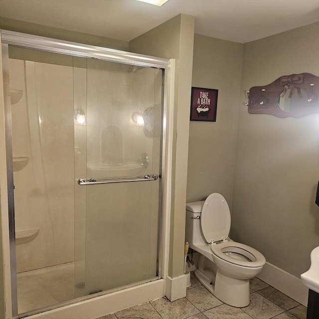 bathroom featuring tile patterned flooring, a shower with door, and toilet