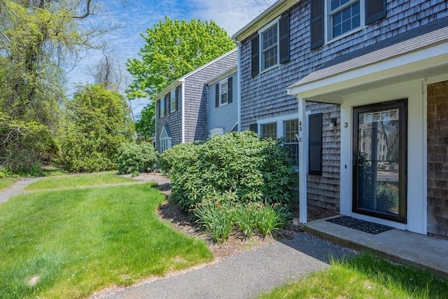 view of exterior entry with a yard