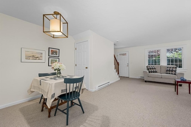 dining space featuring a baseboard heating unit, light carpet, stairs, and baseboards