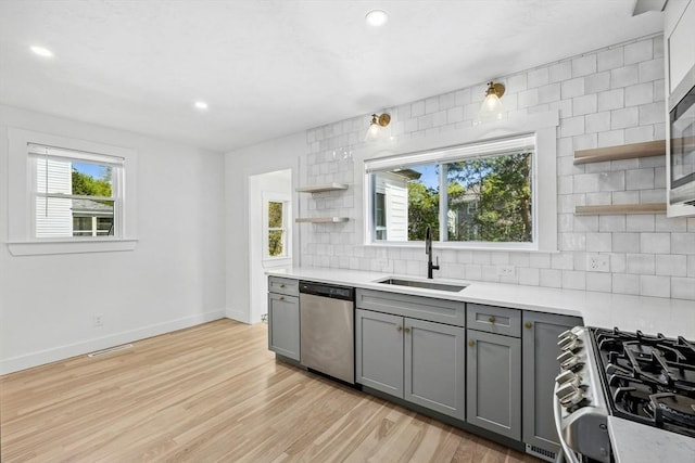 50 Mckinley St Unit 50, Maynard, MA 01754 - kitchen featuring open shelves, gray cabinets, a sink, stainless steel dishwasher, and light countertops