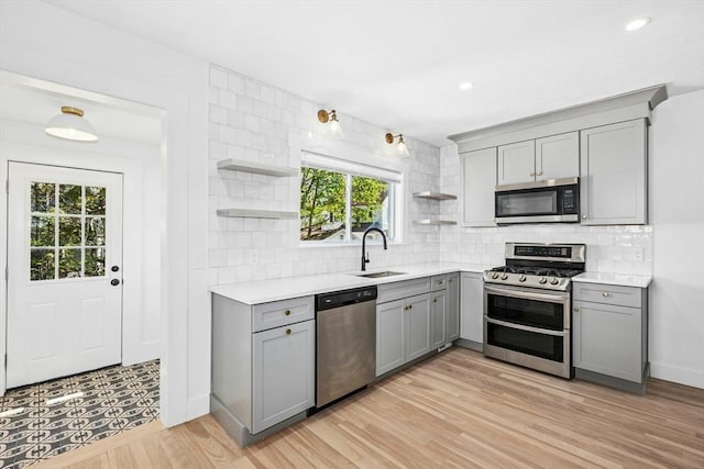 50 Mckinley St Unit 50, Maynard, MA 01754 - kitchen with gray cabinets, stainless steel appliances, open shelves, a sink, and light countertops