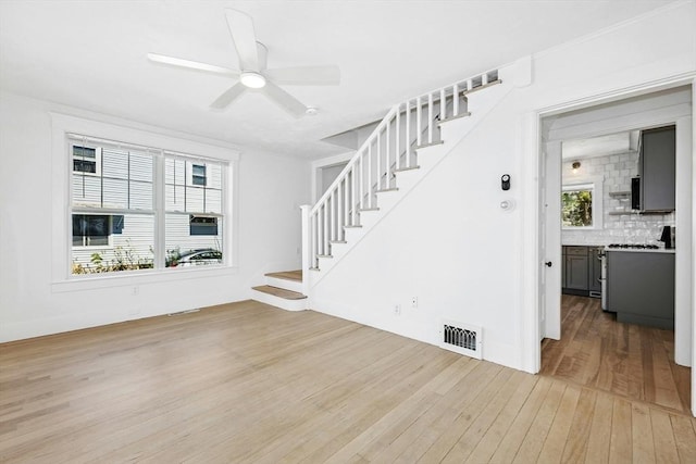 50 Mckinley St Unit 50, Maynard, MA 01754 - unfurnished living room featuring light wood-style flooring, stairway, and a ceiling fan