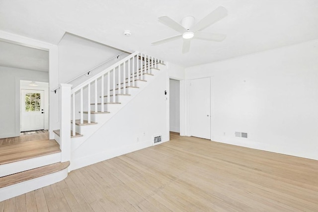 50 Mckinley St Unit 50, Maynard, MA 01754 - unfurnished living room featuring stairway, wood finished floors, and a ceiling fan