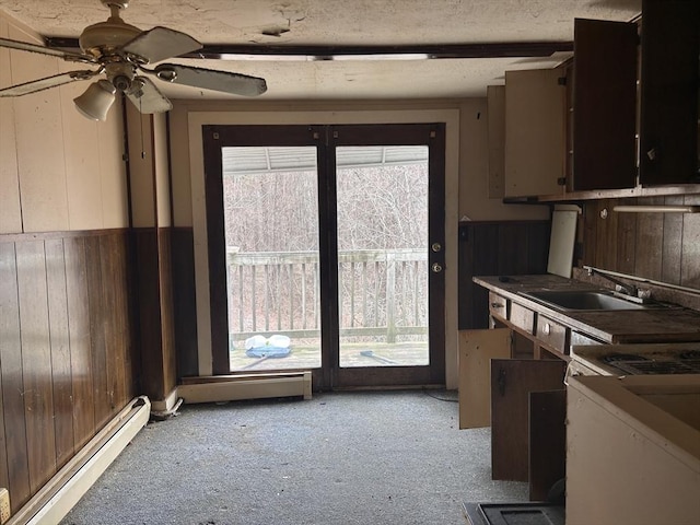 10 Conway Dr, Leicester, MA 01524 - kitchen with baseboard heating, wood walls, light colored carpet, and ceiling fan