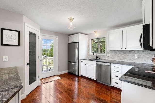 151 Whitehall Rd, Amesbury, MA 01913 - kitchen featuring stainless steel appliances, dark wood-style flooring, plenty of natural light, white cabinets, and a textured ceiling