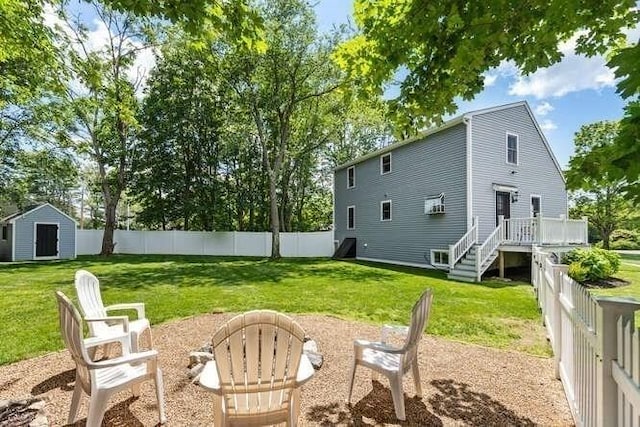 151 Whitehall Rd, Amesbury, MA 01913 - rear view of house featuring a storage shed and a fenced backyard