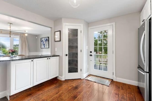 151 Whitehall Rd, Amesbury, MA 01913 - doorway to outside with dark wood-style floors and baseboards