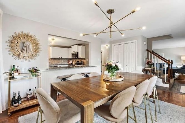151 Whitehall Rd, Amesbury, MA 01913 - dining space with dark wood-type flooring, stairs, and a chandelier