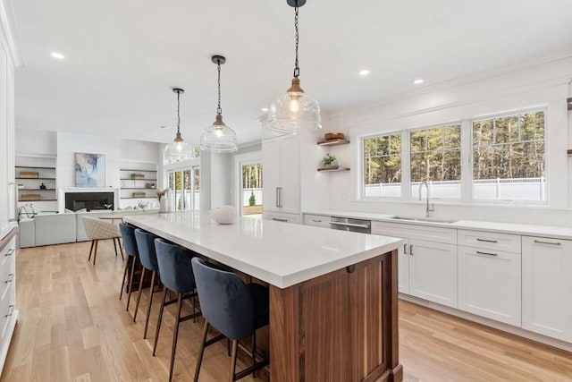 10 Dawson Way, Falmouth, MA 02536 - kitchen with a sink, stainless steel dishwasher, open floor plan, light wood finished floors, and a kitchen island