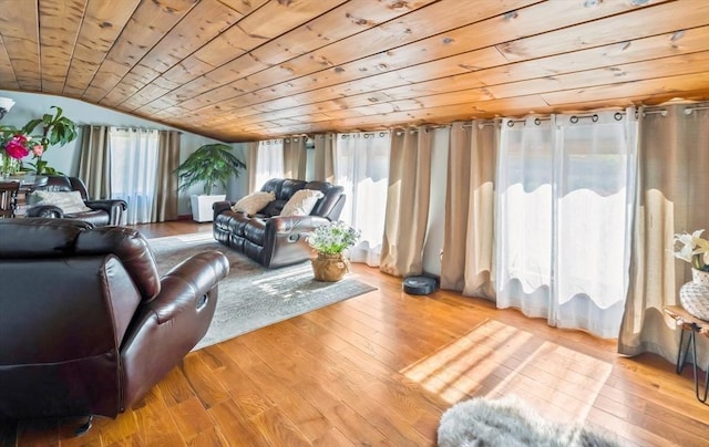living area featuring vaulted ceiling, wooden ceiling, and hardwood / wood-style flooring