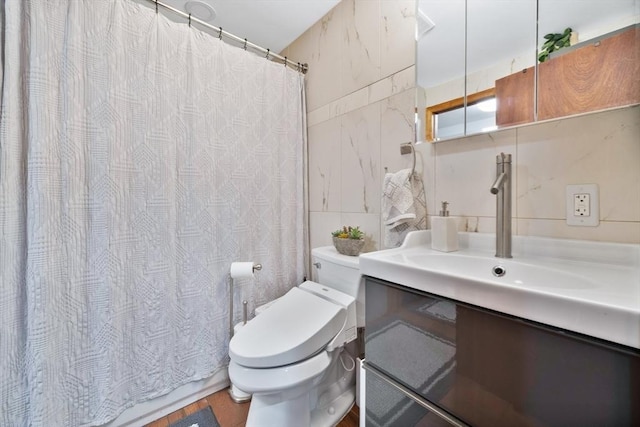 bathroom featuring a shower with curtain, tile walls, wood finished floors, vanity, and toilet
