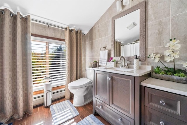 bathroom featuring vanity, tile walls, vaulted ceiling, and toilet