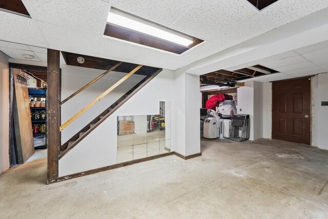 below grade area with stairs and a drop ceiling
