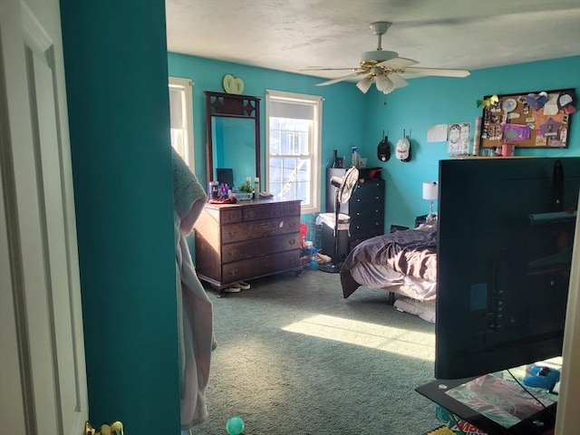 bedroom with ceiling fan and carpet floors