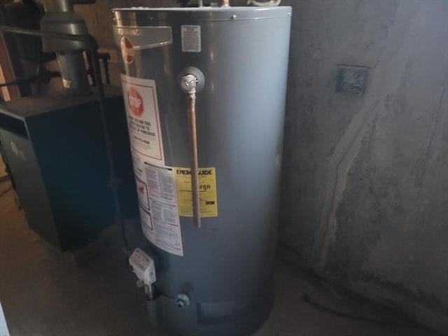 utility room featuring water heater