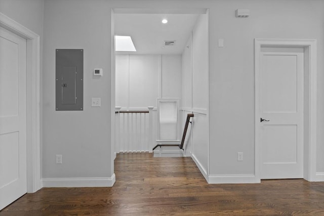 interior space featuring electric panel and dark wood-type flooring