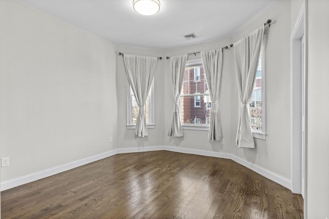 empty room with dark wood-type flooring