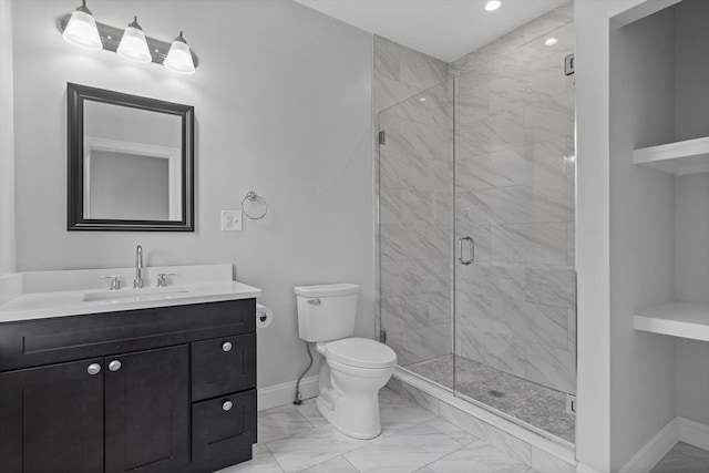 bathroom with a shower with door, vanity, and toilet