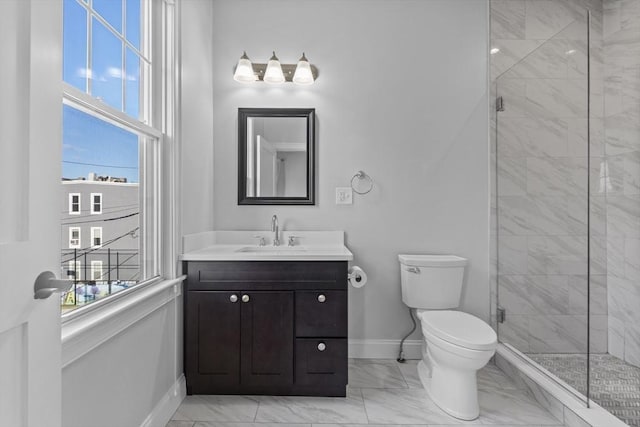 bathroom featuring toilet, vanity, and walk in shower