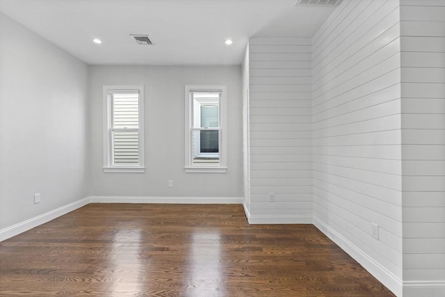 empty room with dark hardwood / wood-style floors