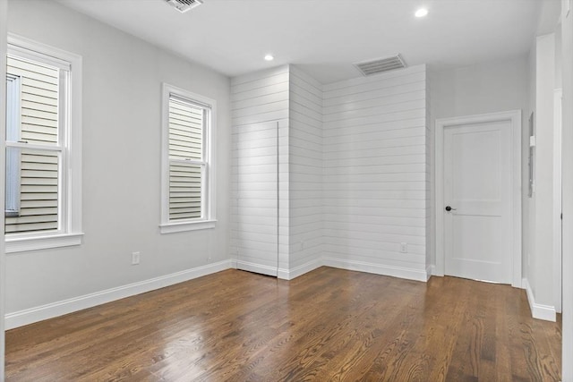 unfurnished room featuring dark hardwood / wood-style floors