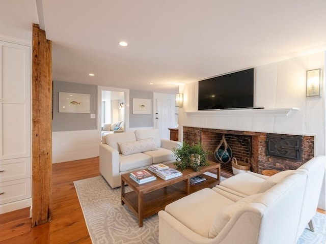 205 Powder Point Ave, Duxbury, MA 02332 - living area with wood finished floors, recessed lighting, and a brick fireplace