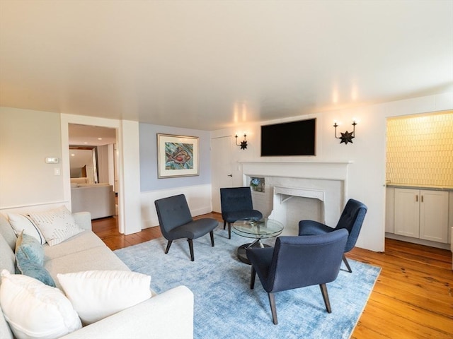 205 Powder Point Ave, Duxbury, MA 02332 - living area with light wood finished floors and a fireplace with flush hearth