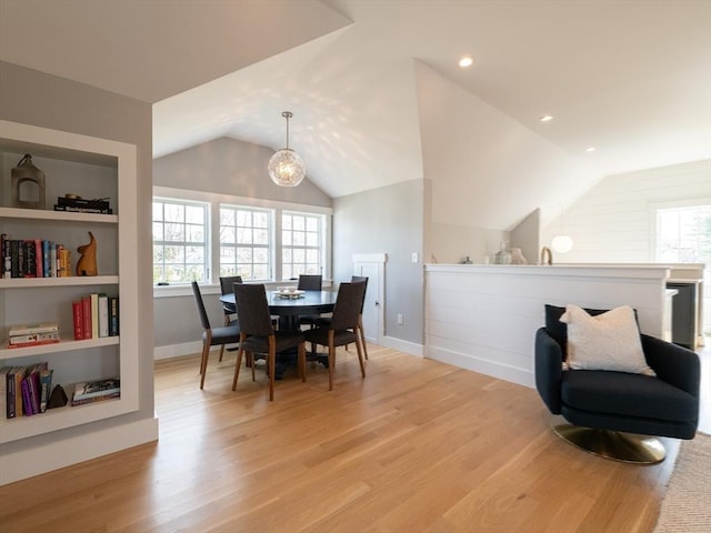 205 Powder Point Ave, Duxbury, MA 02332 - dining room with light wood finished floors, baseboards, vaulted ceiling, and built in shelves