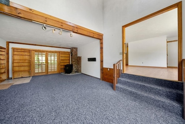 52 Richard Rd, Hanson, MA 02341 - unfurnished living room featuring carpet floors and a wood stove
