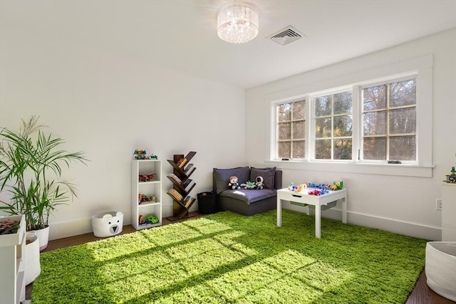 recreation room with baseboards and visible vents