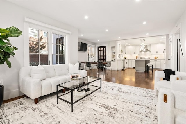 living area featuring recessed lighting, baseboards, and wood finished floors