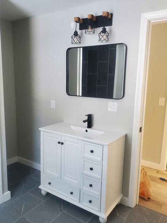 bathroom with vanity and baseboards