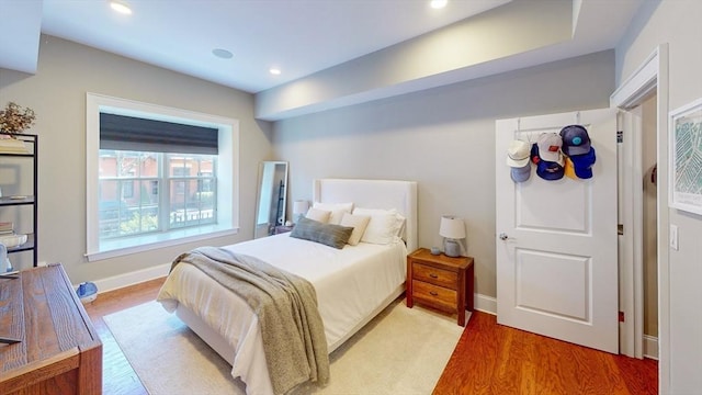 bedroom featuring recessed lighting, light wood-style flooring, and baseboards