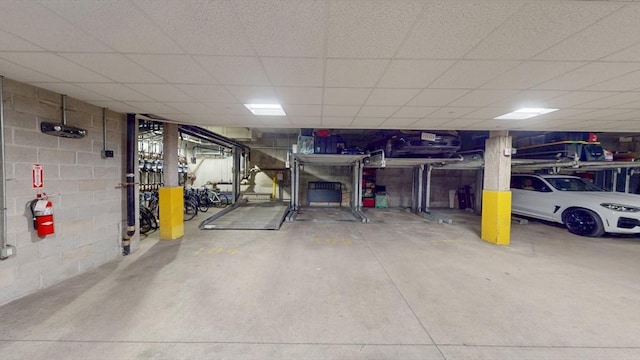 parking garage featuring concrete block wall
