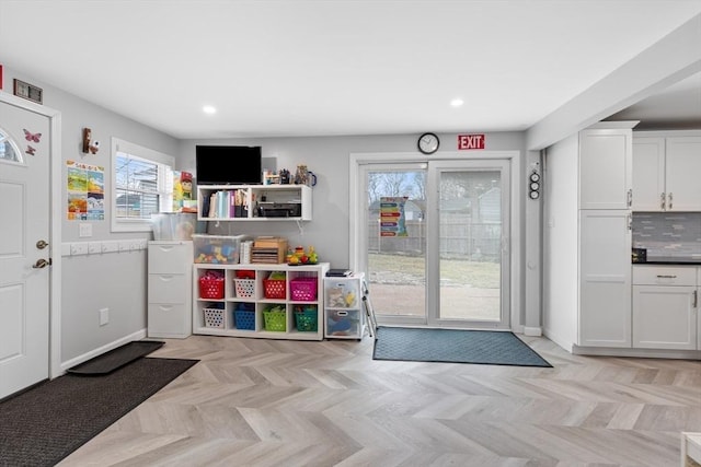 rec room with light parquet flooring