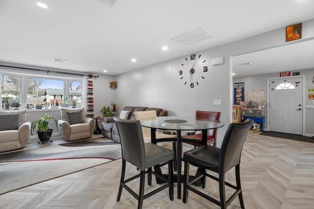 dining space featuring light parquet floors