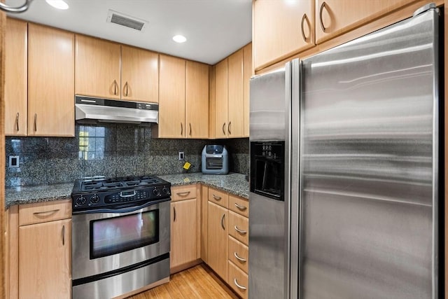 kitchen featuring appliances with stainless steel finishes, visible vents, under cabinet range hood, and light brown cabinetry