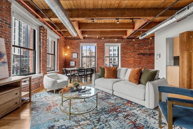 living room with wooden ceiling, brick wall, wood finished floors, beamed ceiling, and track lighting