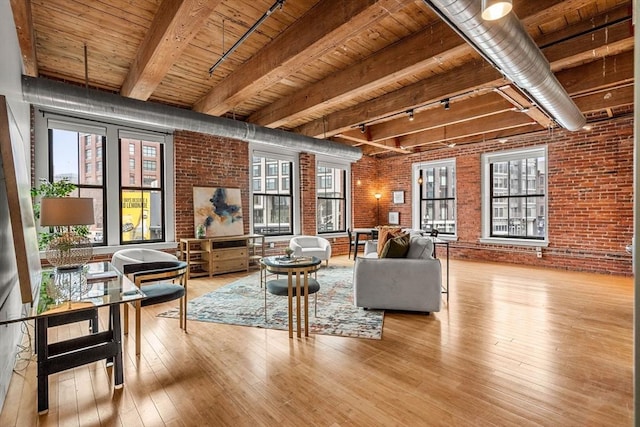 living area with wood ceiling, brick wall, beam ceiling, and hardwood / wood-style flooring