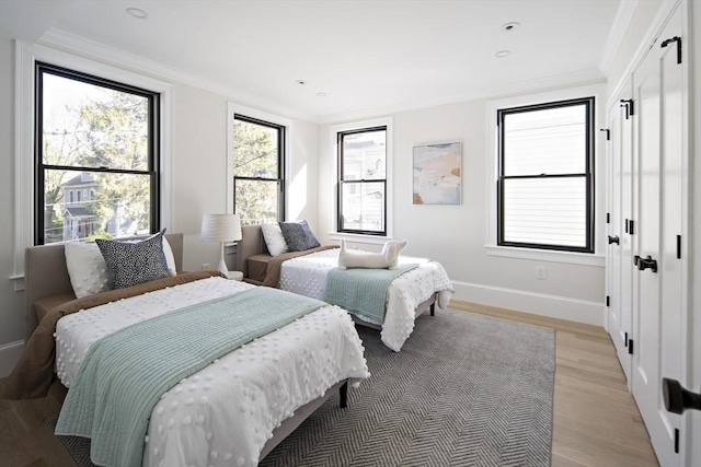 133 Fayerweather St Unit 1, Cambridge, MA 02138 - bedroom featuring light wood-style floors, crown molding, and recessed lighting