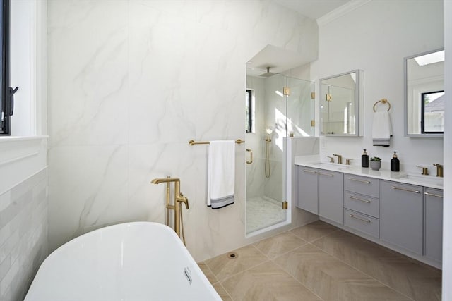 133 Fayerweather St Unit 1, Cambridge, MA 02138 - full bath with a marble finish shower, tile walls, double vanity, a freestanding tub, and ornamental molding