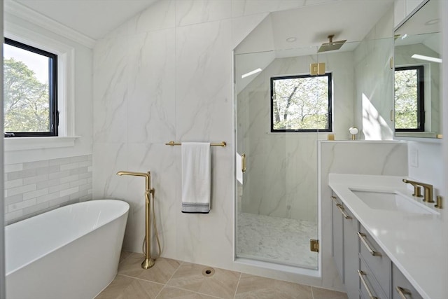 133 Fayerweather St Unit 1, Cambridge, MA 02138 - bathroom with tile walls, a marble finish shower, vanity, a freestanding tub, and tile patterned flooring