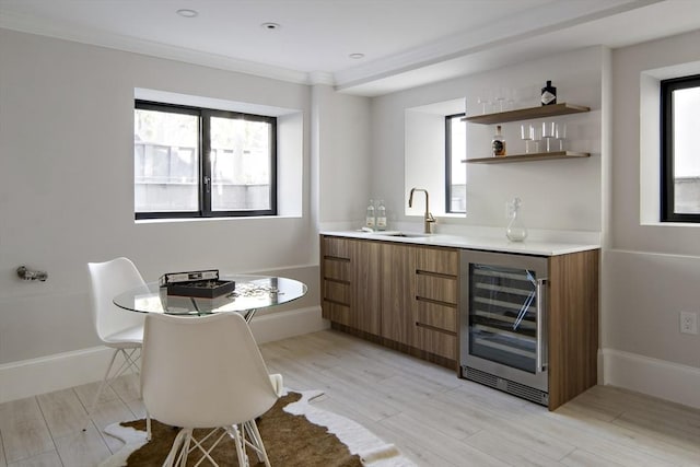 133 Fayerweather St Unit 1, Cambridge, MA 02138 - indoor wet bar featuring wine cooler, light wood-style flooring, plenty of natural light, and ornamental molding