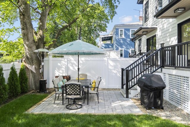 133 Fayerweather St Unit 1, Cambridge, MA 02138 - fenced backyard with grilling area, a patio area, and outdoor dining area